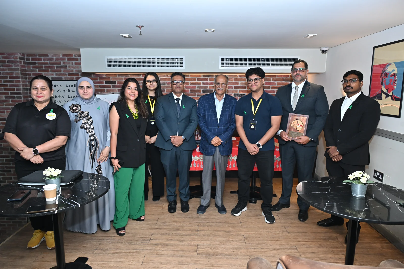 Professor Ahmed Malallah Al-Ansari standing with organisers and participants at Caring for the Caregiver in Bahrain
