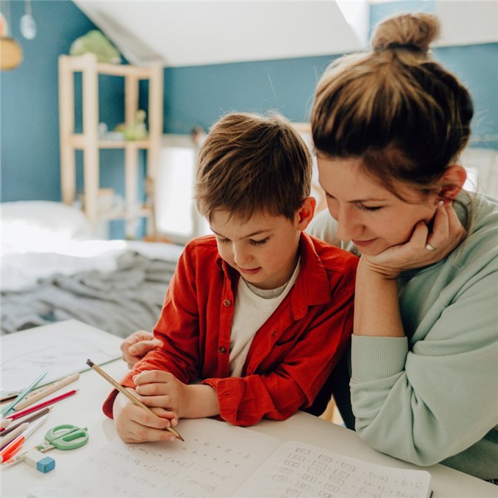 A parent and child working on an activity together