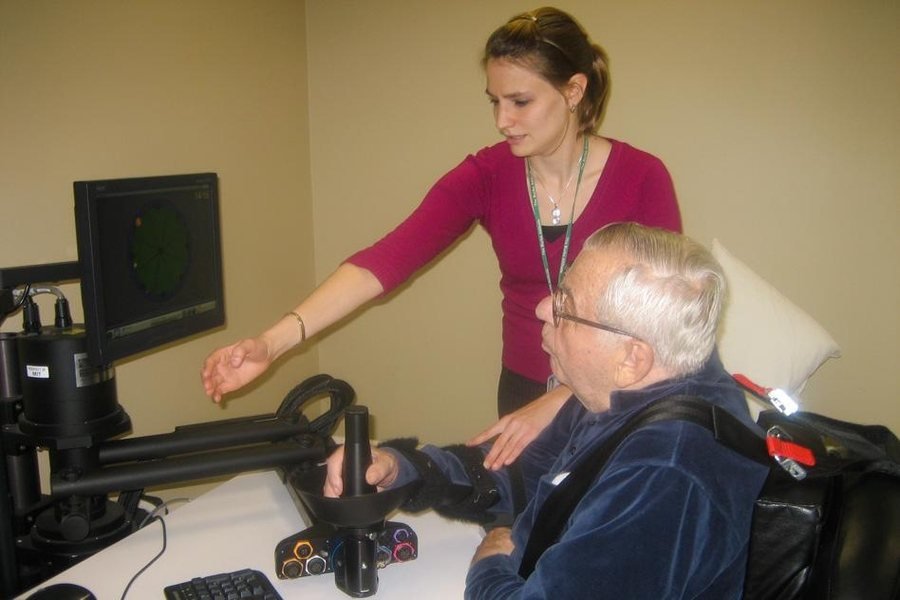 An older adult receiving guidance during a computer-based activity