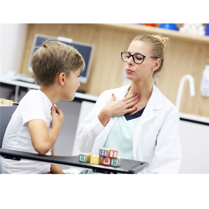 A professional guiding a child through a communication activity